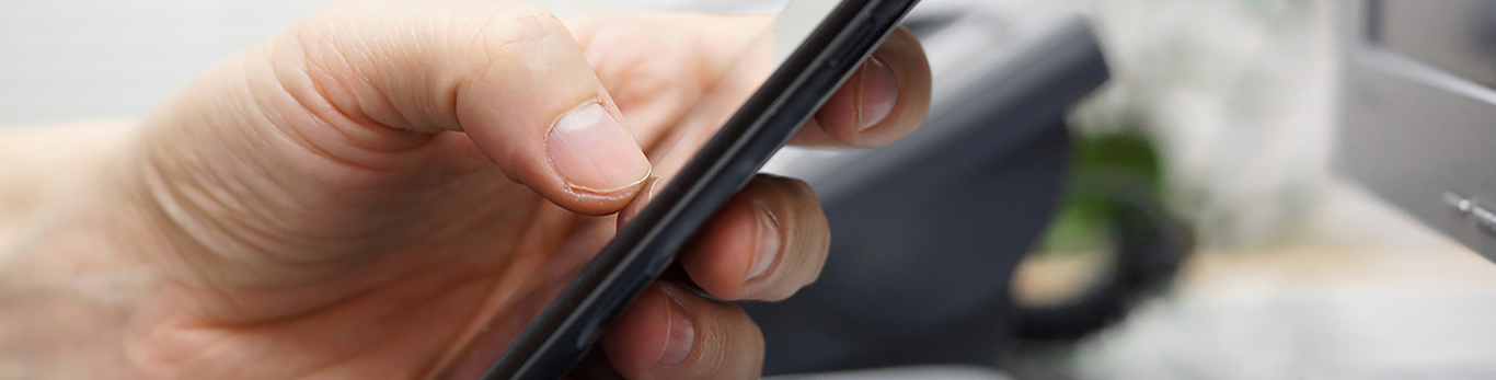Image of hands using a mobile phone.